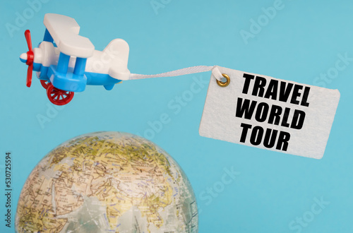 Photography On a blue background, a globe and an airplane with a sign - Travel world tour