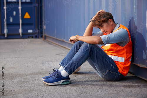 factory worker or engineer feeling tired and disappointed from work in containers warehouse storage