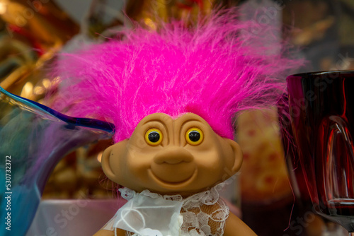 A toy doll with hot pink hair