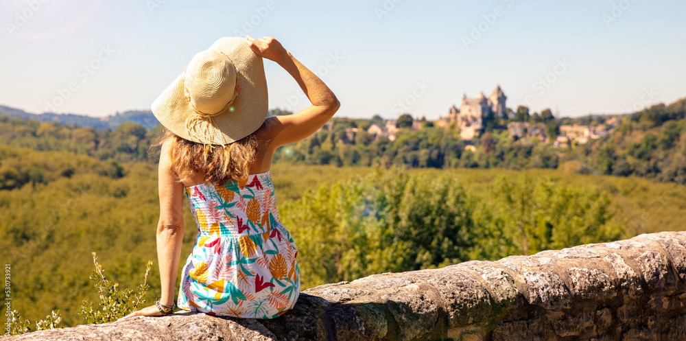 Woman tourist looking at viewpoint of cingle of Monfort (dordogne, perigord, correze)