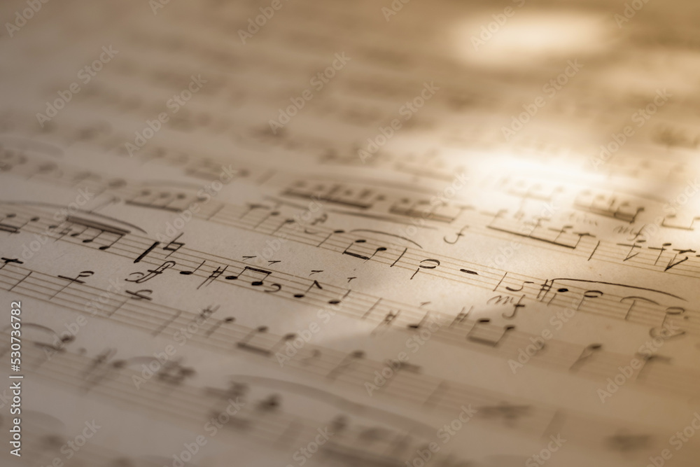 Background of musical notes: score for piano, close-up. Sheet with music notes. Conservatory, music, sheet music, music lessons, artistic life concept Background of musical notes: score for piano, close-up. Sheet with music notes. Conservatory, music, sheet music, music lessons, artistic life concept