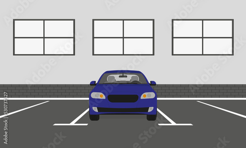 Blue car in the parking lot in front of the building