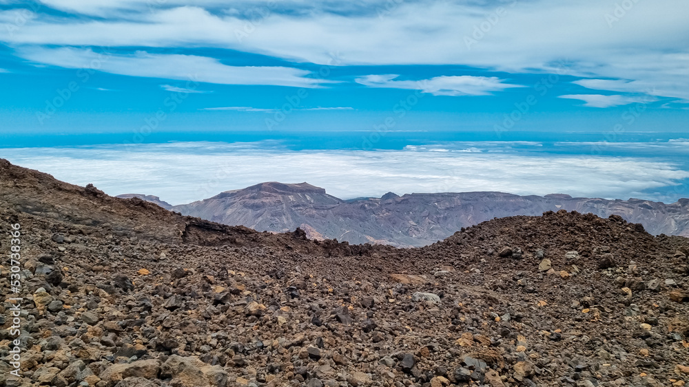 Hiking trail over volcanic desert terrain leading to summit of volcano Pico del Teide from Pico Viejo, Mount Teide National Park, Tenerife, Canary Islands, Spain, Europe. Solidified lava, ash, pumice