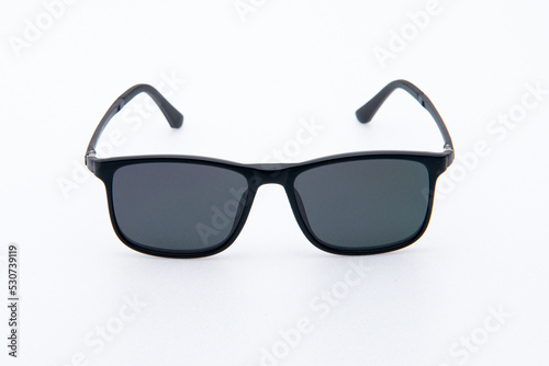 Fashion sunglasses black frames on white background. © krilerg
