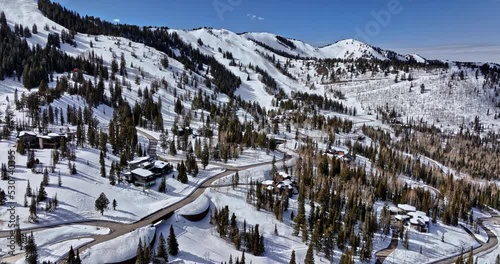 Park City Utah Aerial v39 flyover the colony white pine canyon capturing luxury private mansions on snowy mountain and dense coniferous forest with blue sky - Shot with Mavic 3 Cine - February 2022 photo