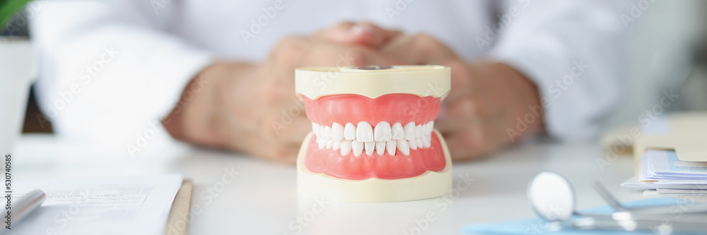 Dentist and layout beautiful even white teeth closeup