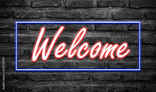 Message Welcome with effect neon light on black brickwall