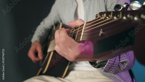 Close-up of the guitar playing. Beautiful guitar playing in the studio. Guitar lesson. High quality 4k footage