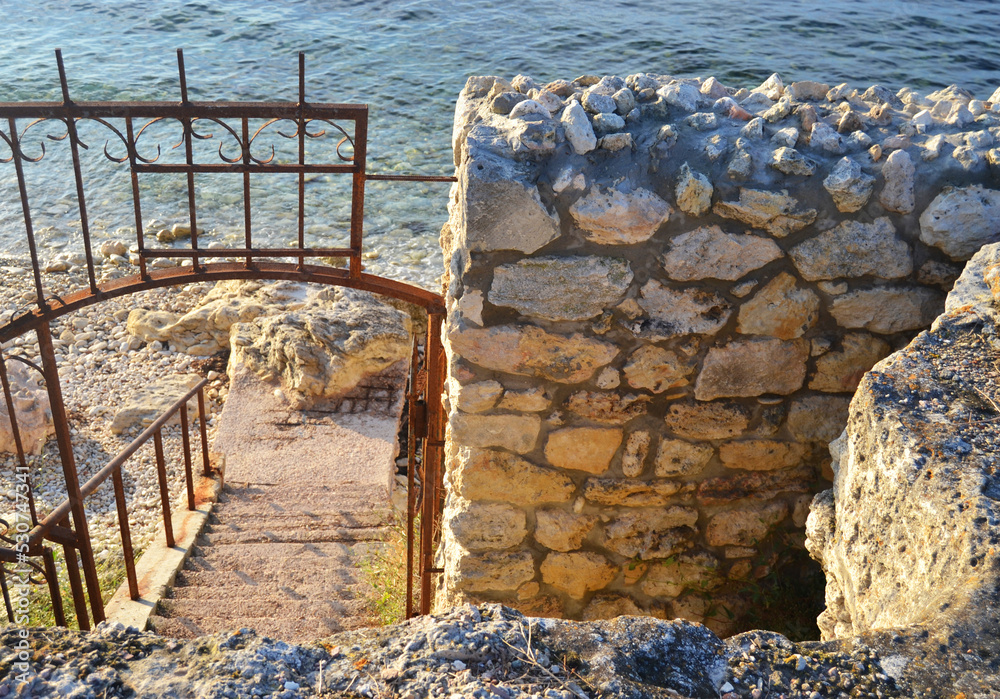 Old staircase with colick leading to the sea