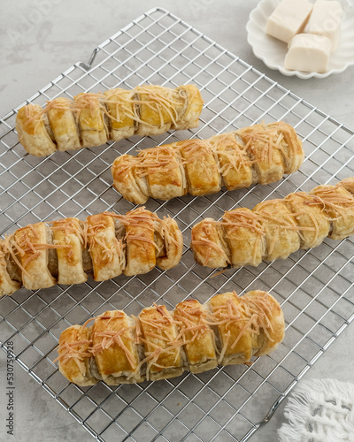 Bolen Pisang is a light dish made from bananas covered in rolled sheets of pastry dough with cheese topping
 photo