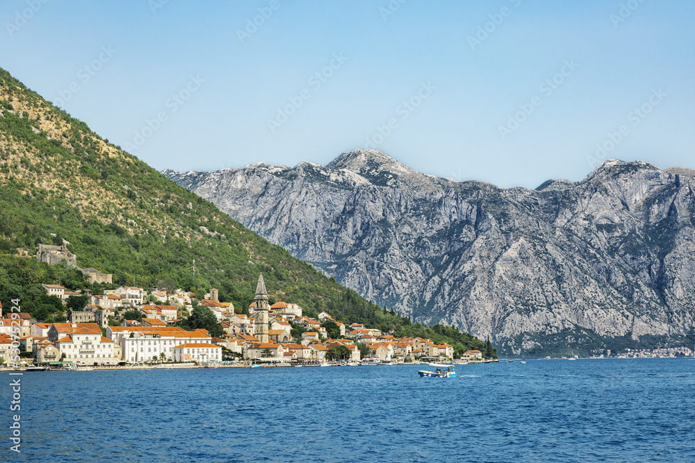 View from the sea to a small town and mountains. Mountain landscape. Adriatic Sea. Beautiful places in Montenegro.