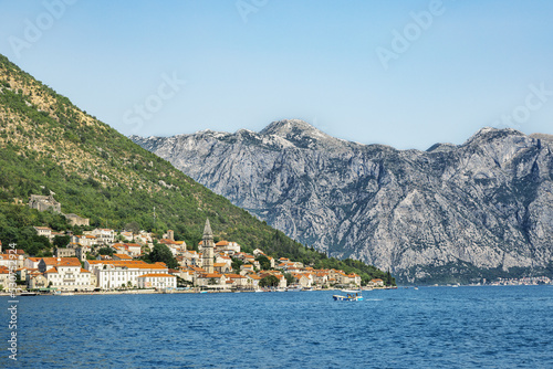 View from the sea to a small town and mountains. Mountain landscape. Adriatic Sea. Beautiful places in Montenegro.