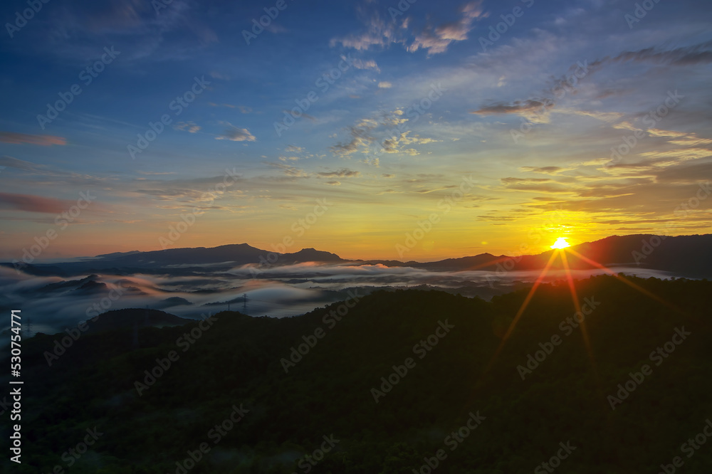 Aerial view Beautiful  panorama of morning scenery Golden light sunrise And the mist flows on high mountains forest. Pang Puai, Mae Moh, Lampang, Thailand.
