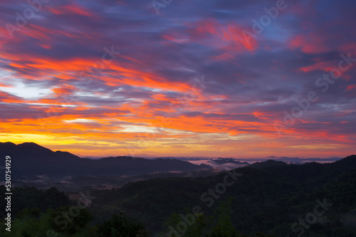 Aerial view Beautiful panorama of morning scenery Golden light sunrise And the mist flows on high mountains forest. Pang Puai, Mae Moh, Lampang, Thailand.