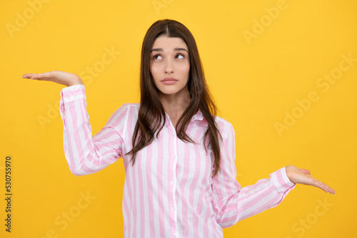 Woman point at copy space, showing copyspace pointing. Promo, girl showing advertisement content gesture, pointing with hand recommend product. Isolated background.