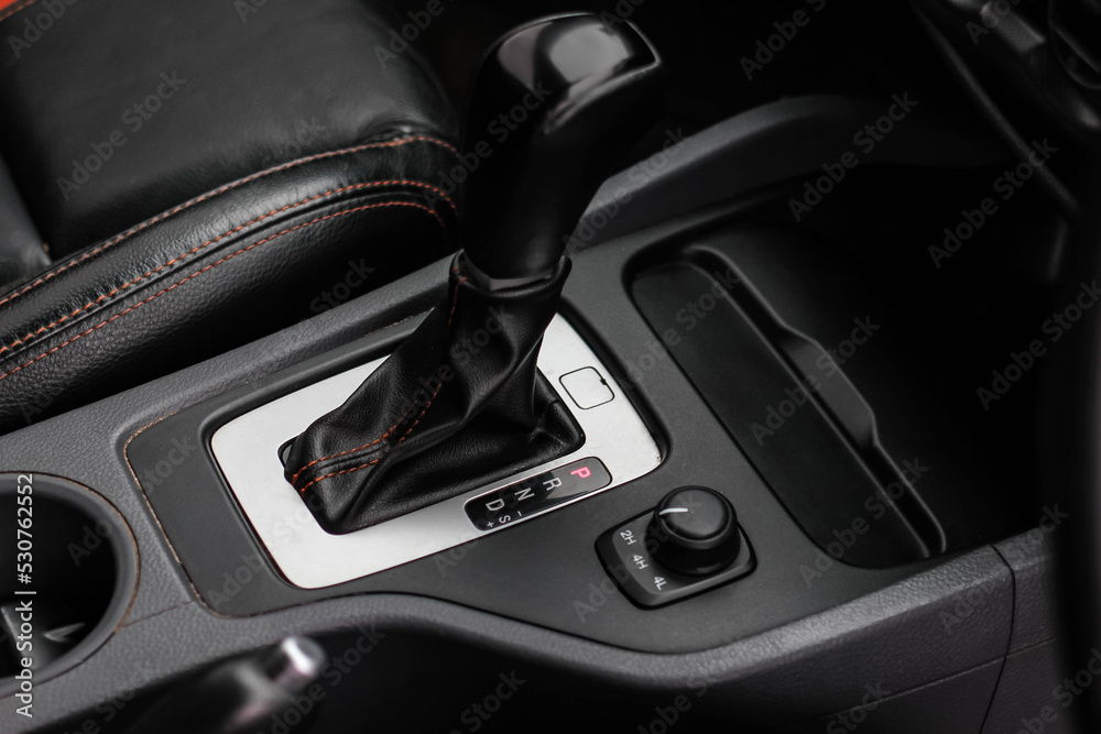 automatic transmission shift selector in the car interior. Closeup a manual shift of modern car gear shifter. 4x4 gear shift automatic transmission shift selector in the car interior. Closeup a manual shift of modern car gear shifter. 4x4 gear shift