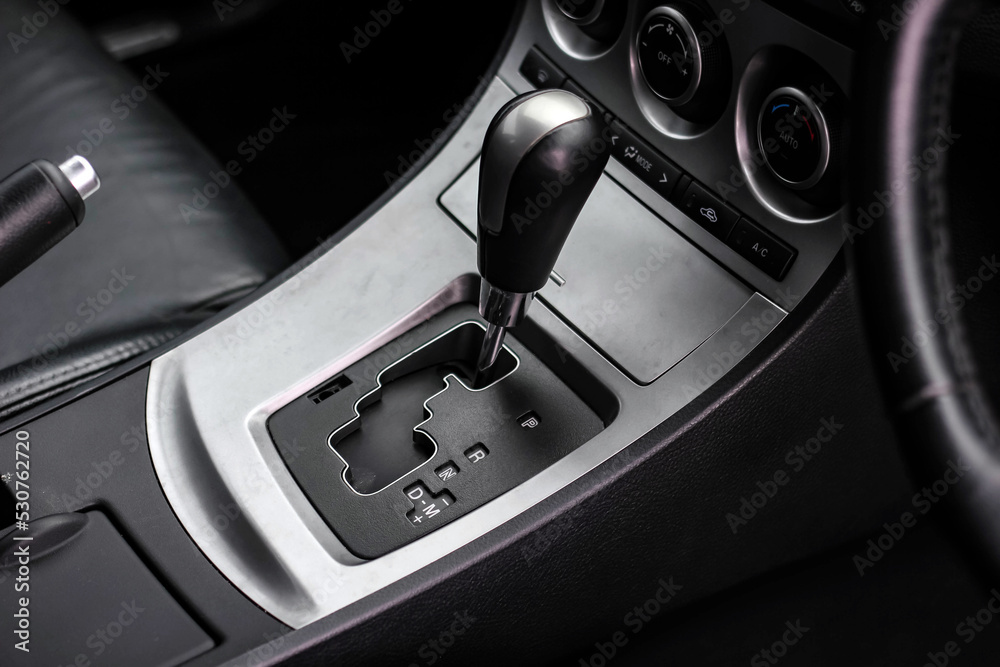 automatic transmission shift selector in the car interior. Closeup a manual shift of modern car gear shifter. 4x4 gear shift automatic transmission shift selector in the car interior. Closeup a manual shift of modern car gear shifter. 4x4 gear shift