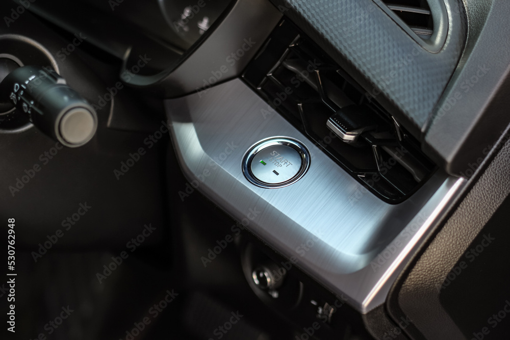Close up engine car start button. Start stop engine modern new car button,Makes it easy to turn your auto mobile on and off. a key fob unique ,selective focus Close up engine car start button. Start stop engine modern new car button,Makes it easy to turn your auto mobile on and off. a key fob unique ,selective focus