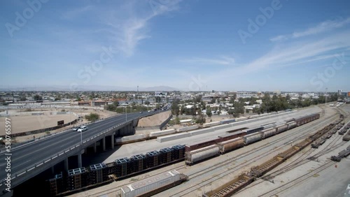 View of a drone flying back from a street bridge and train tracks photo