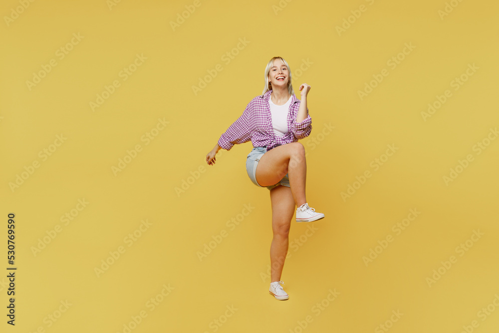 Full body young blonde woman 20s wear pink tied shirt white t-shirt doing winner gesture celebrate clenching fists say yes isolated on plain yellow background studio portrait People lifestyle concept Full body young blonde woman 20s wear pink tied shirt white t-shirt doing winner gesture celebrate clenching fists say yes isolated on plain yellow background studio portrait People lifestyle concept