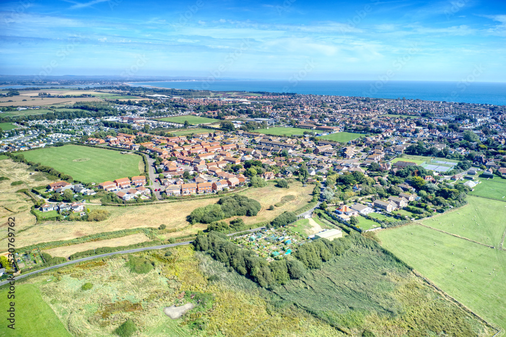 Aerial view towards the small town of Selsey in West Sussex Southern England which is surrounded by countryside and fields.