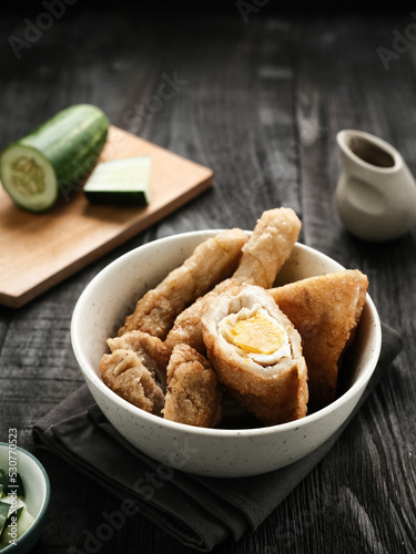 Pempek, Empek-Empek, traditional food from South Sumatra, Indonesia. This fish-based food is very popular. Served with cuko sauce and cucumber slices.
 photo