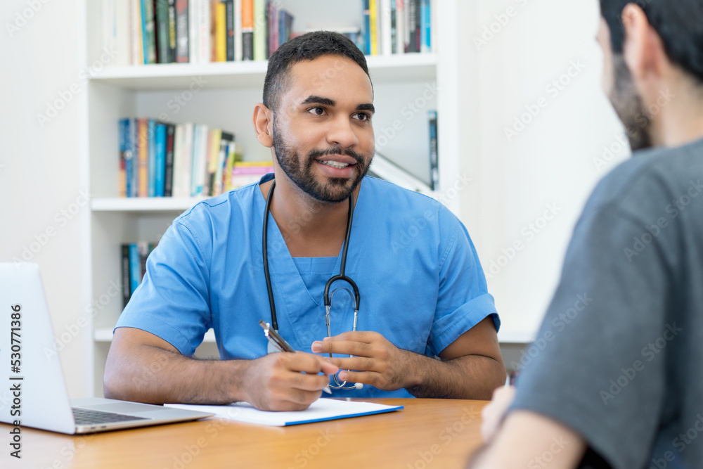 Young hispanic doctor or nurse talking with patient Young hispanic doctor or nurse talking with patient