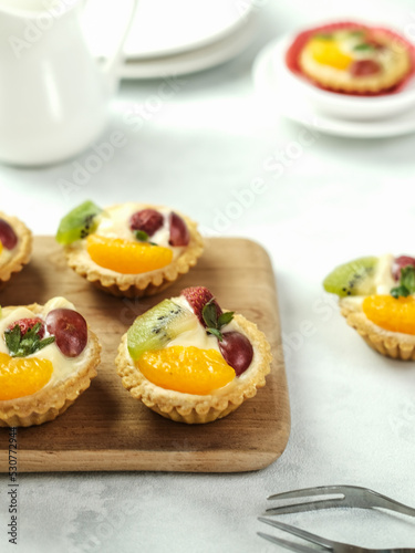 Delicious mini pie with fresh fruits, close up 