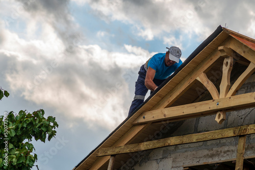Roofer man roof carpenter working Country house renovation.