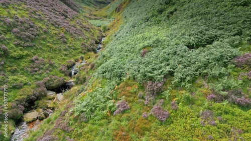 Slow moving waterfall stream flowing down a moorland valley in West Yorkshire, England. Moorlands above the village town of Marsden, Huddersfield. photo