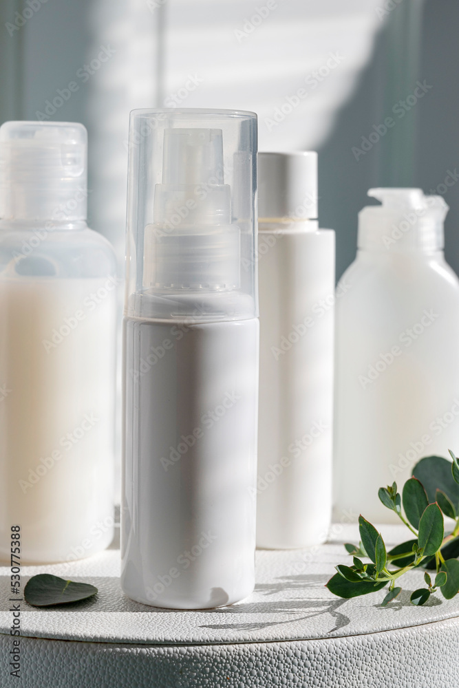 White, plastic beauty products bottle. Blank cosmetics bottle. White, plastic beauty products bottle. Blank cosmetics bottle.