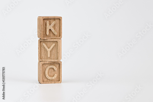 KYC know your customer guidelines in financial services theme. wooden cubes with the acronym KYC, on white background photo