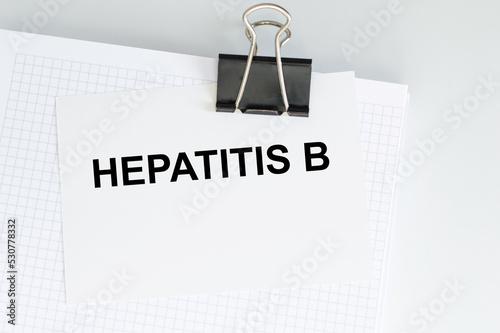 A card with text HEPATITIS B on a table, medical concept