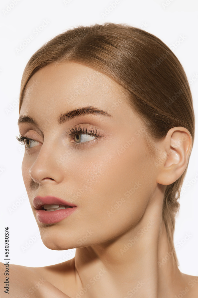 Portrait of young beautiful girl with well-kept skin and light daily makeup isolated on white background. Beauty, spa, cosmetics, face lifting and skin care concept Portrait of young beautiful girl with well-kept skin and light daily makeup isolated on white background. Beauty, spa, cosmetics, face lifting and skin care concept
