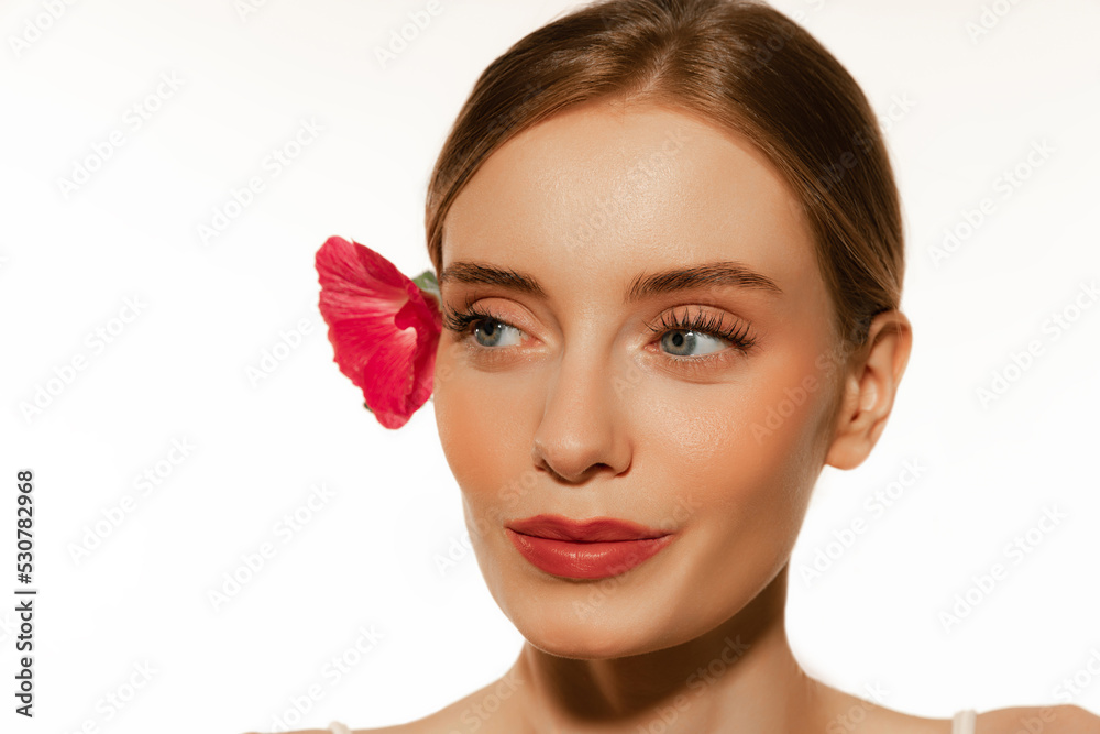 Fototapeta premium Closeup portrait of beautiful young girl with clean well-kept skin isolated over white background. Skin care. Facial treatment. Cosmetology, beauty and spa.