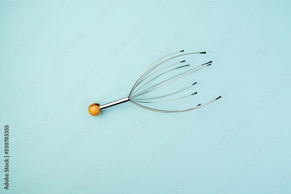 Manual massage for the head device. Allows you to relax and get rid of stress. Blue background Manual massage for the head device. Allows you to relax and get rid of stress. Blue background
