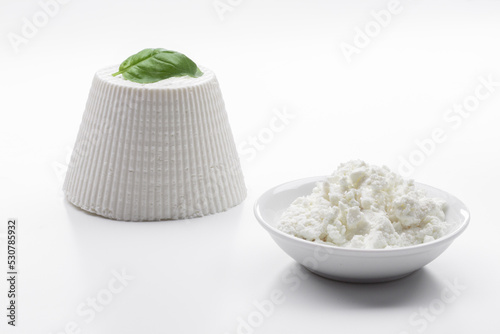 whole ricotta with basil leaf on a white background