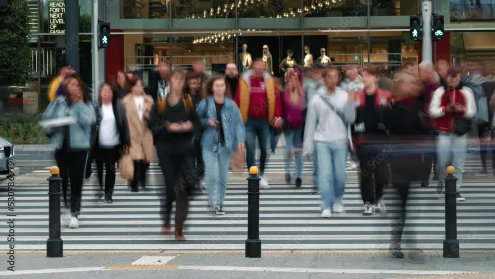 Time-lapse unrecognizable people crowd crossing city street, busy crossroad, pedestrians crossing crosswalk intersection, car traffic. Timelapse rush hour crowded people walk, daylight, fast motion
