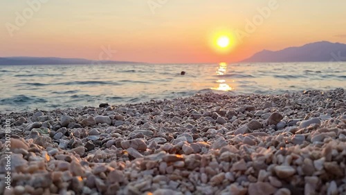 View of beautiful footage while big sea waves breaking on the coastline. Beautiful red sunset over the Adriatic sea. Makarska Riviera-Biokovo, Dalmatia, Croatia, Europe