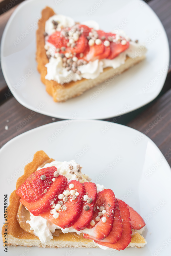 A beautiful dessert of sponge cake and cream with strawberries A beautiful dessert of sponge cake and cream with strawberries
