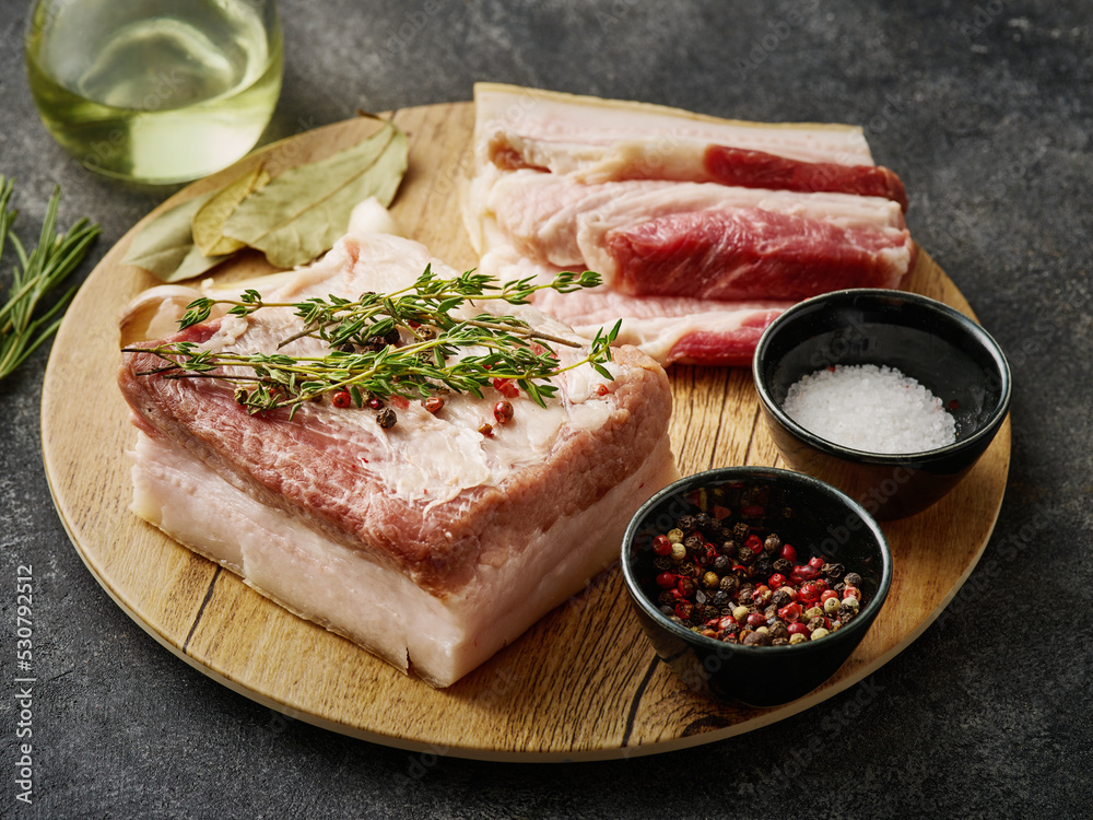 Korean Traditional BBQ Pork. Raw Pork belly. Fresh pork belly, salt, pepper and garlic on wooden board Korean Traditional BBQ Pork. Raw Pork belly. Fresh pork belly, salt, pepper and garlic on wooden board