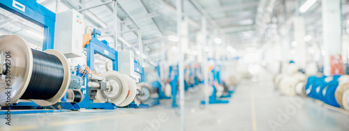 industrial production of fiber optic cable for telecommunication systems. Production of modern fiberglass and fiber optic cables at the plant. Copy space for text on blurred background.
