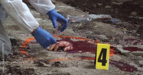 Forensic detective, taking a blood or DNA sample from the scene of a horrific crime
