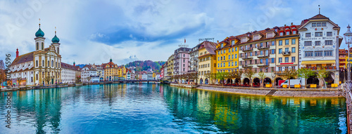 Fashionable historical houses on the banks of Reuss river are the visit card of old town in Lucerne, Switzerland