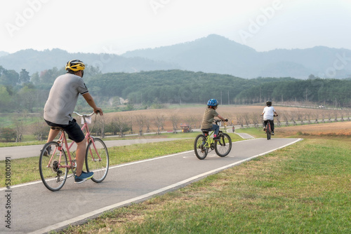 People are doing exercises on bicycles on the streets in the park.