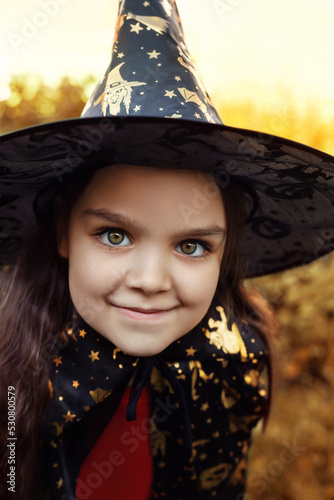 Baby girl in a witch costume. Halloween celebration.