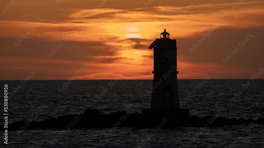 wonderful sunset at the lighthouse of the mangarche in calasetta, south sardinia, italy

