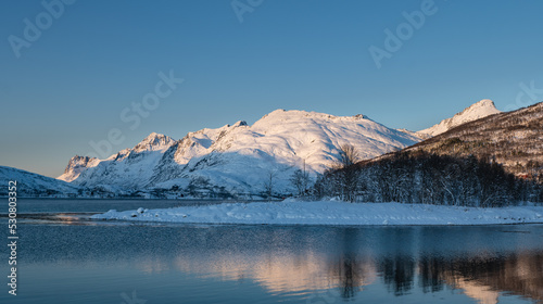 Sunset over the Norwegian fjord, winter photos at the golden hour, Tromso, Norway 