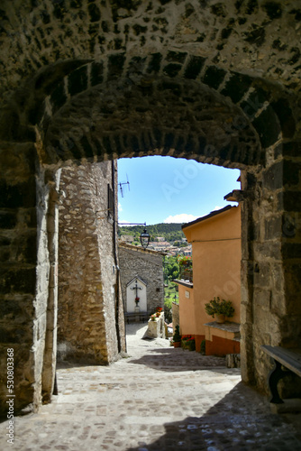 A narrow street between the old stone houses of Barrea, a medieval village in the Abruzzo region of Italy.