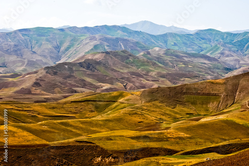 Fields and mountains in the north of Afghanistan near Faizabad city photo